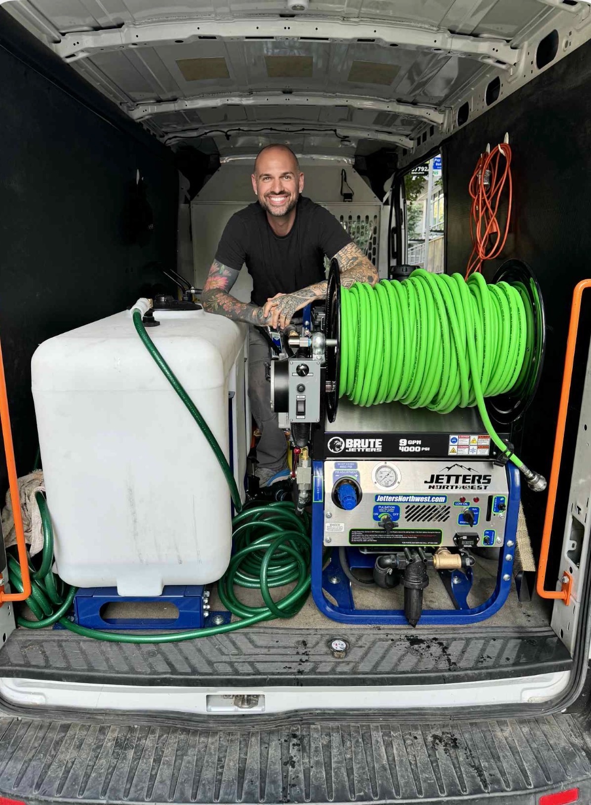 The Drain Authority owner with professional hydro jetting equipment in Seattle service van